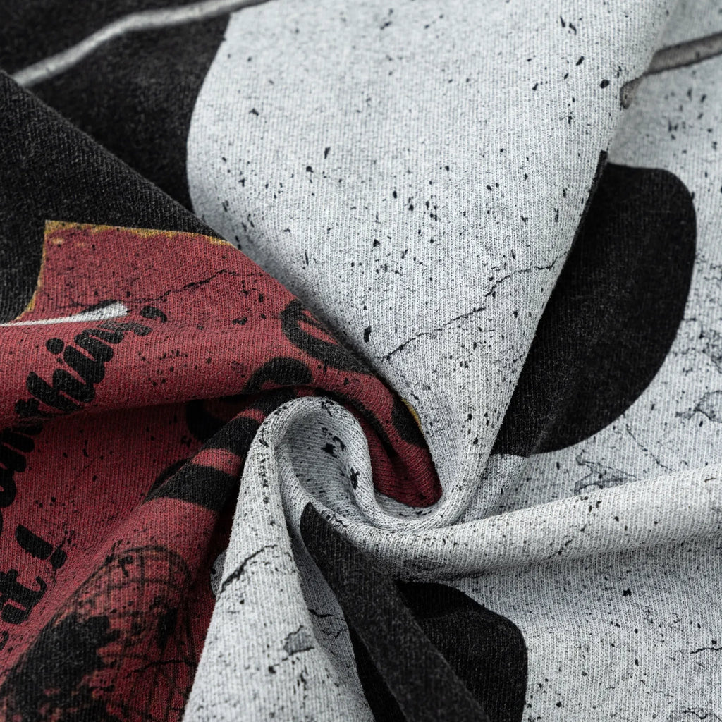 Close-up of textured fabric with a mix of colors including gray, black, and red.