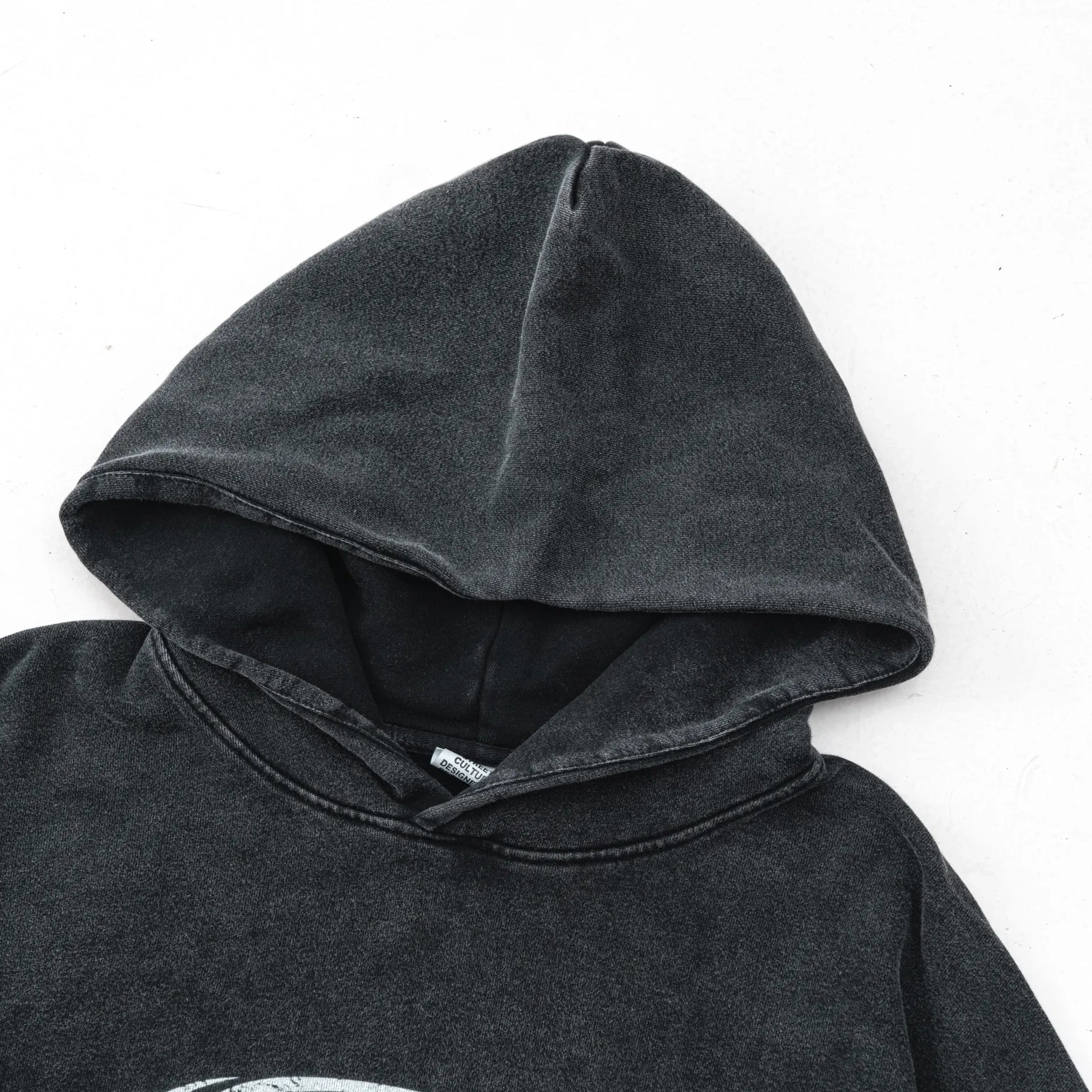Dark gray hoodie with a brand label on a white background