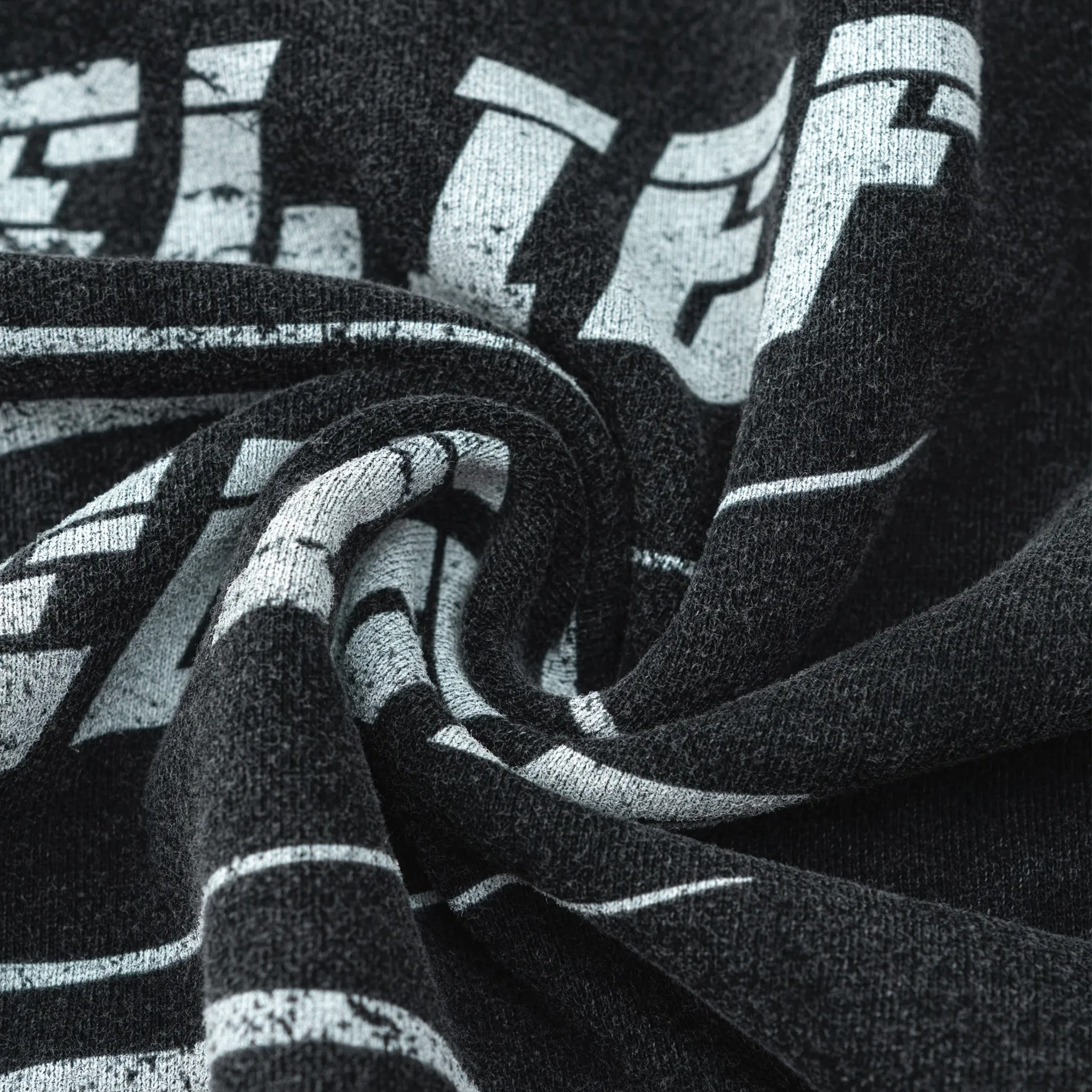 Close-up of black and gray striped fabric with 'ELLE' branding.