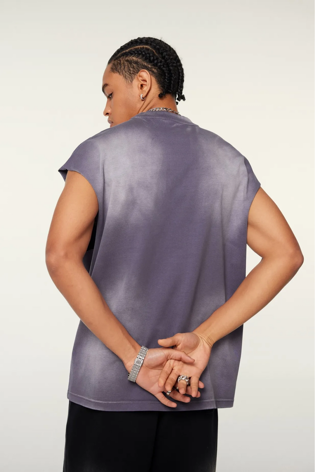 Person wearing a purple top with a plain background