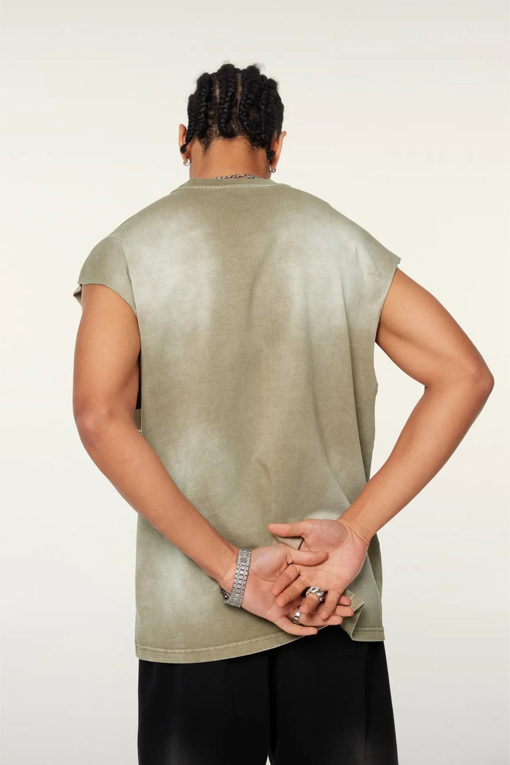 Person wearing a sleeveless green shirt on a white background