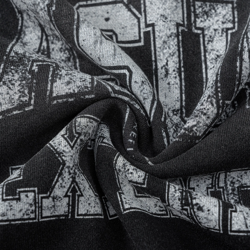 Close-up of a black and gray patterned fabric with visible branding.
