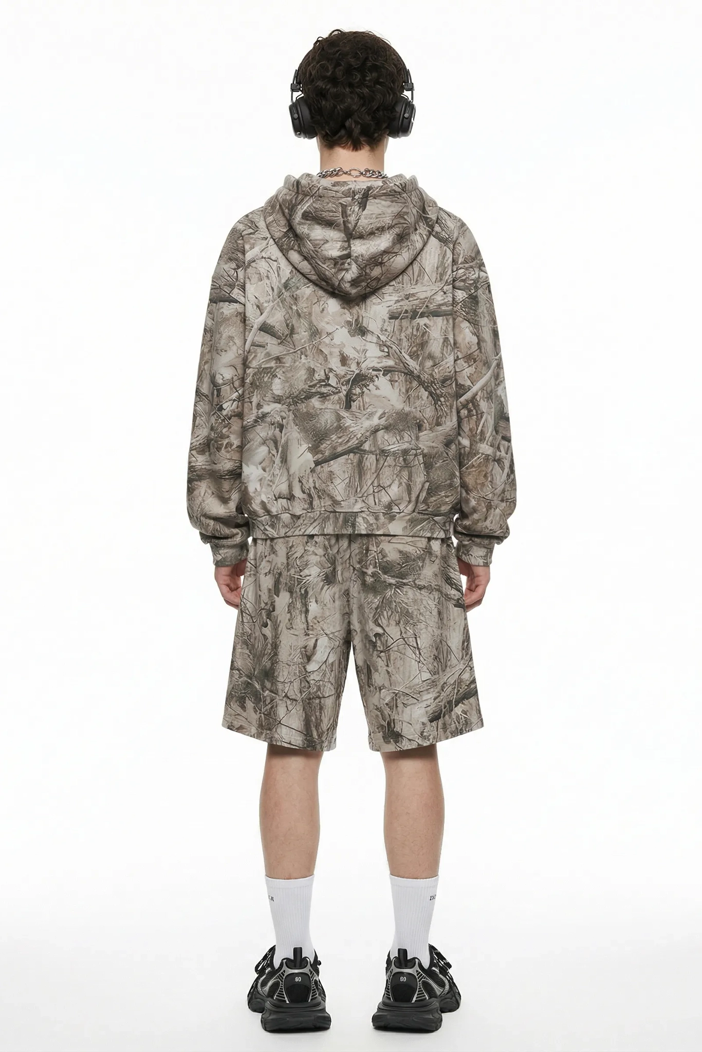 Person wearing a camouflage outfit on a white background