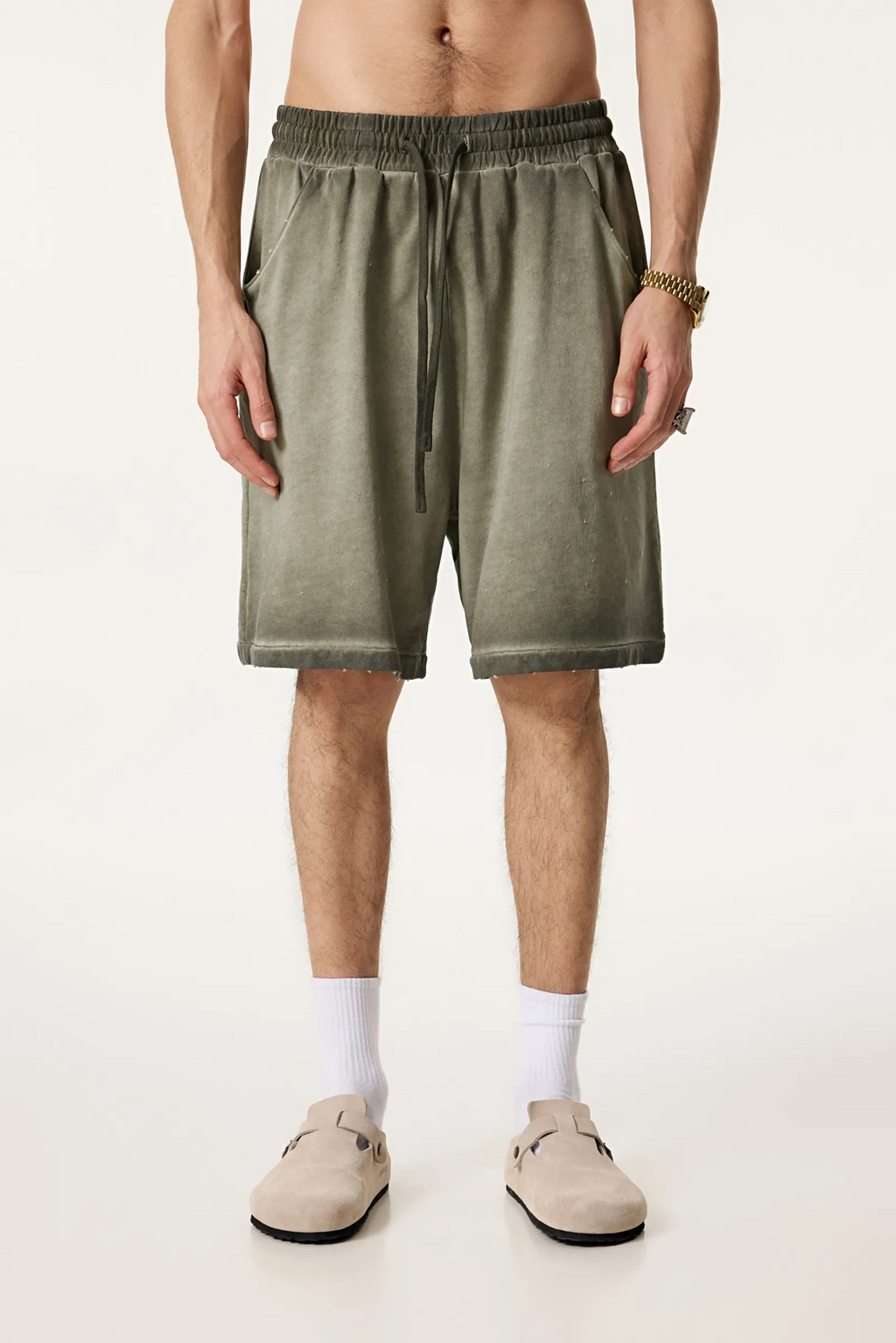 Person wearing green shorts on a white background
