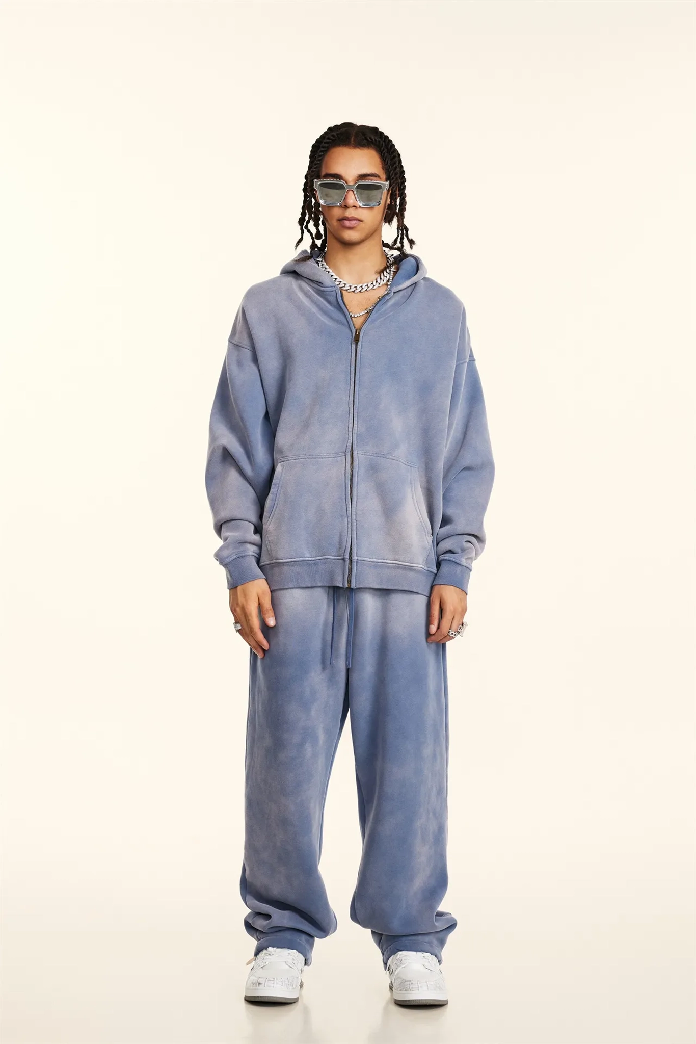 Person wearing a blue tracksuit on a white background