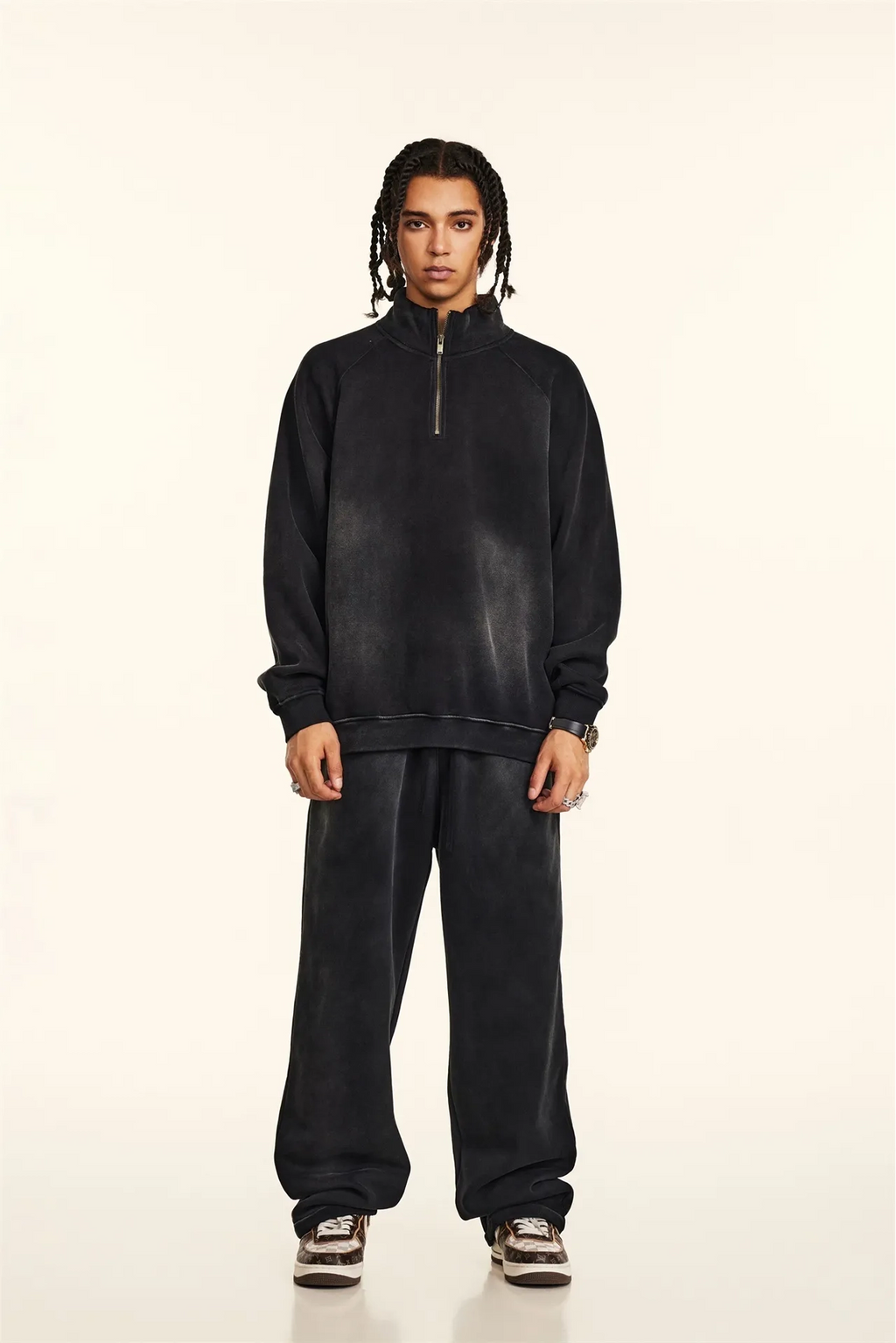 Person wearing a black tracksuit on a white background