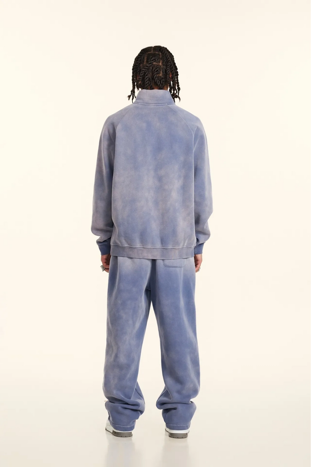 Person wearing a blue tracksuit on a white background