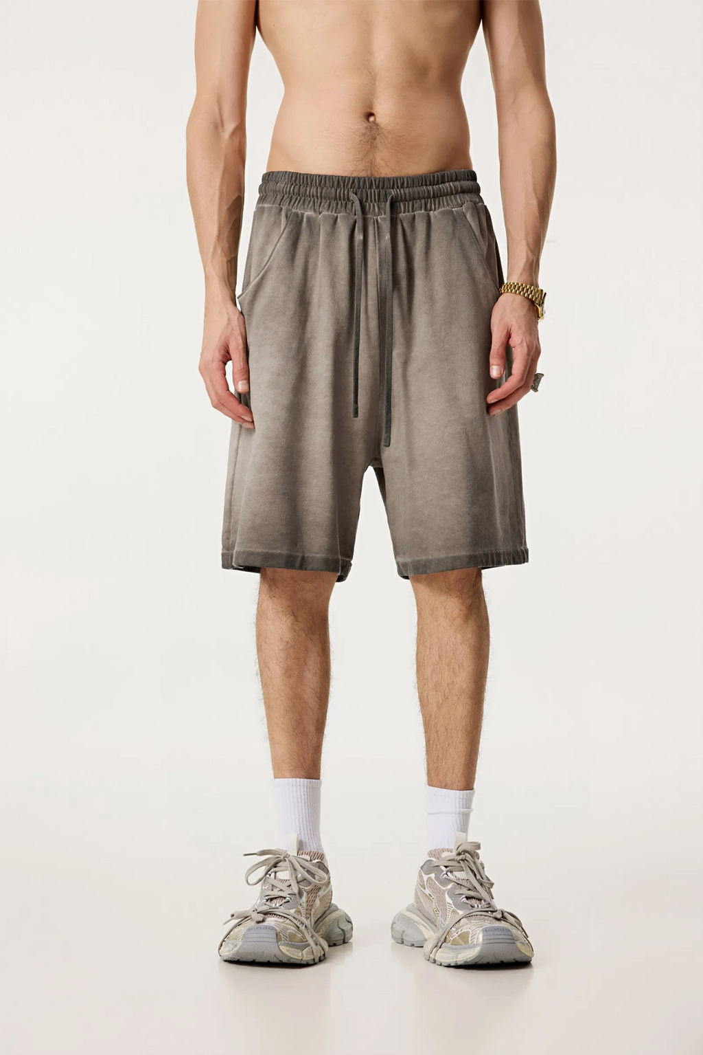 Man wearing brown shorts on a white background