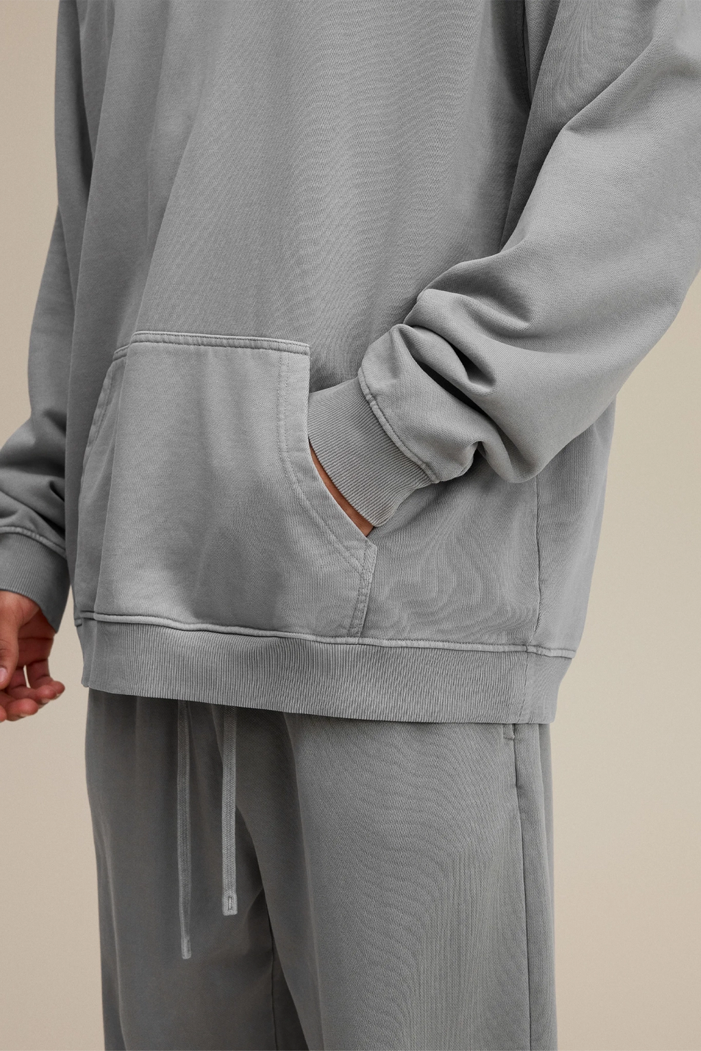 Gray sweatshirt and pants set on a beige background