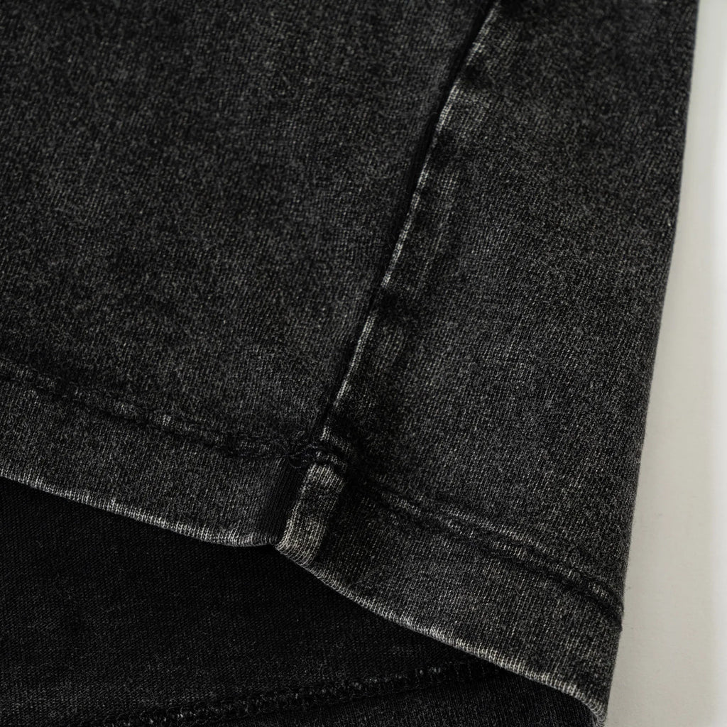 Close-up of black denim fabric with a white background