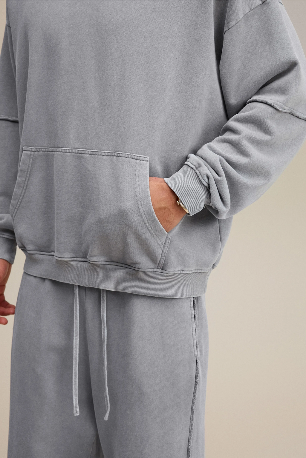 Gray sweatshirt and pants set on a neutral background