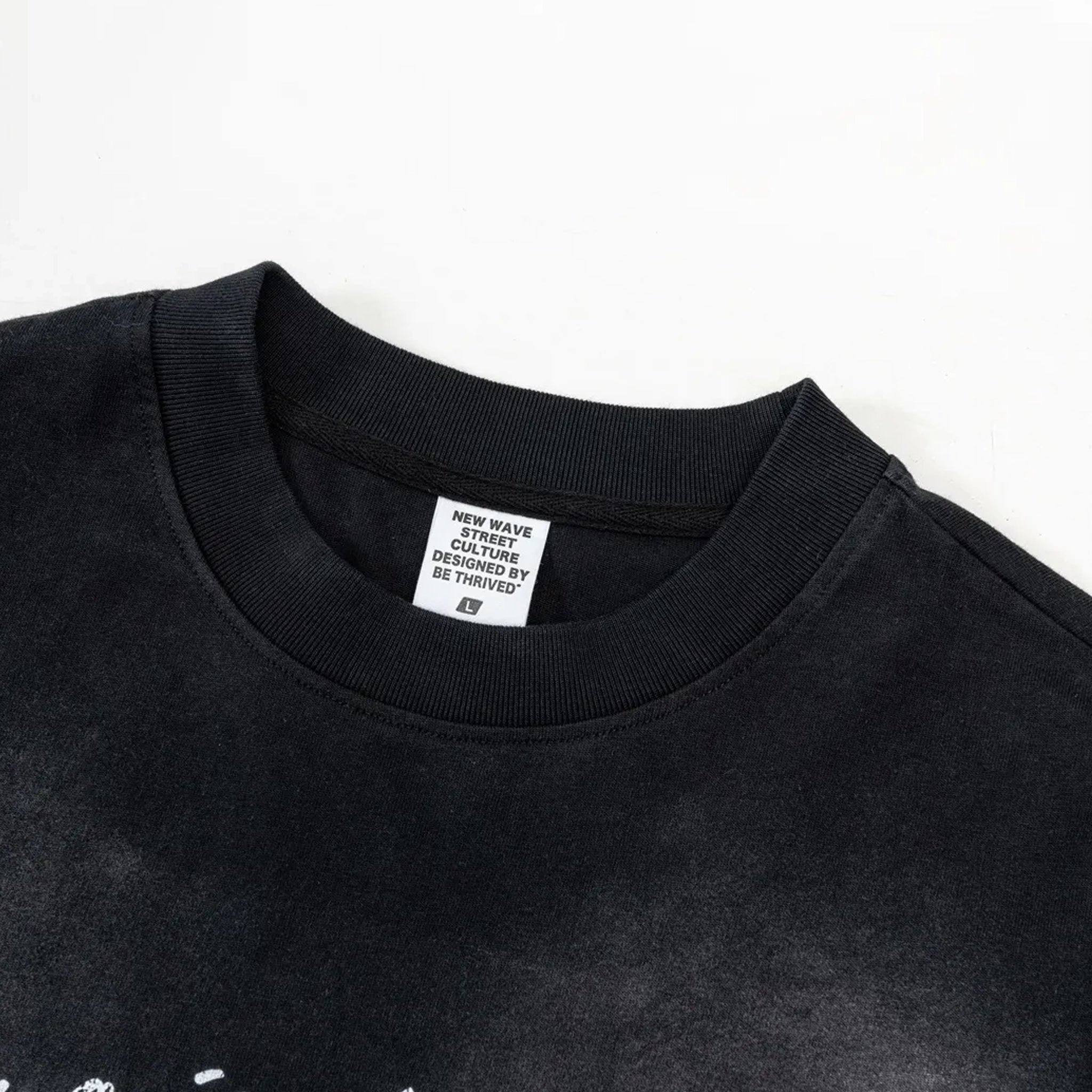 Black t-shirt with a visible brand label on a white background