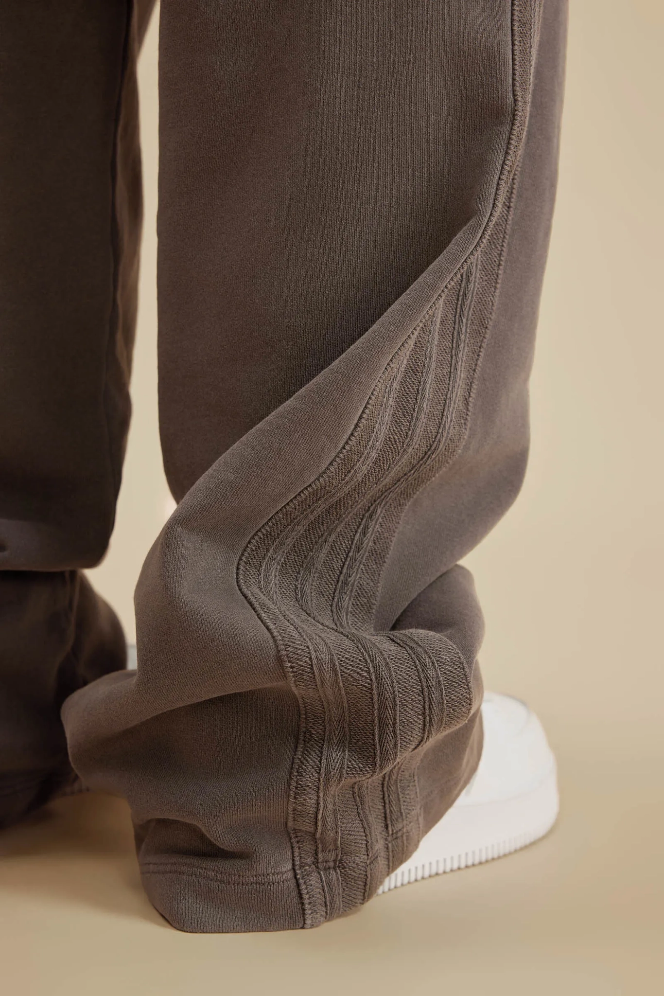 Brown pants with a white sole on a beige background