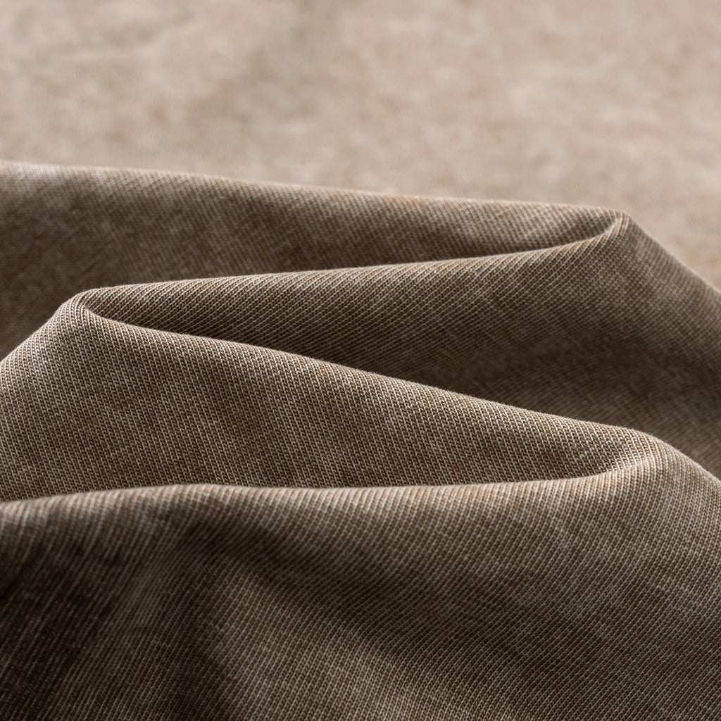 Close-up of brown fabric with a subtle texture