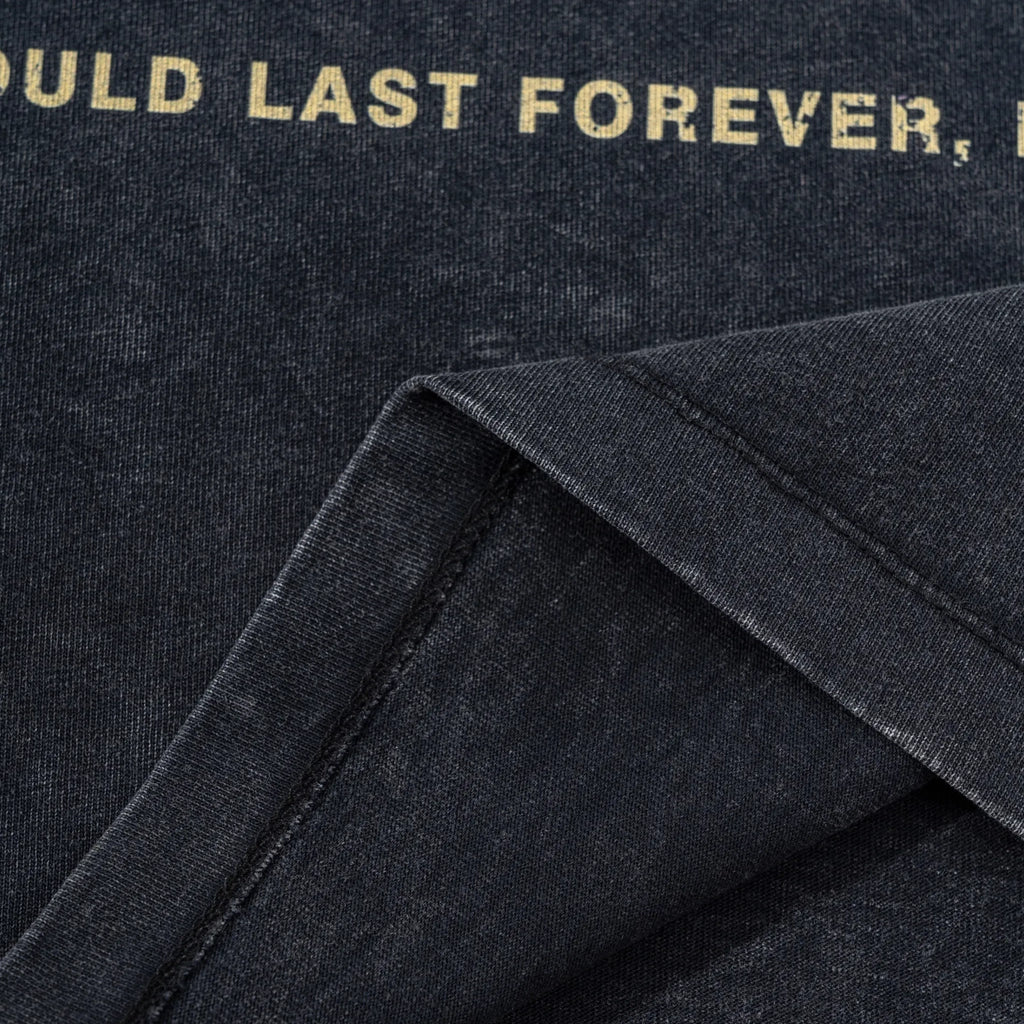 Close-up of a dark fabric with gold text on a black background