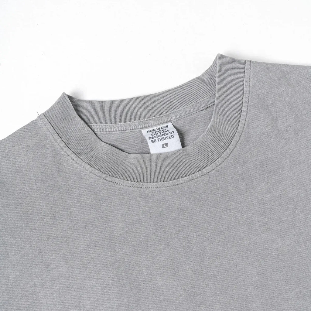 Gray t-shirt with a brand label on a white background