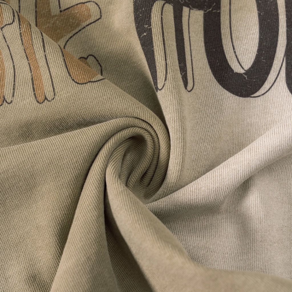 Close-up of beige fabric with printed text and shapes