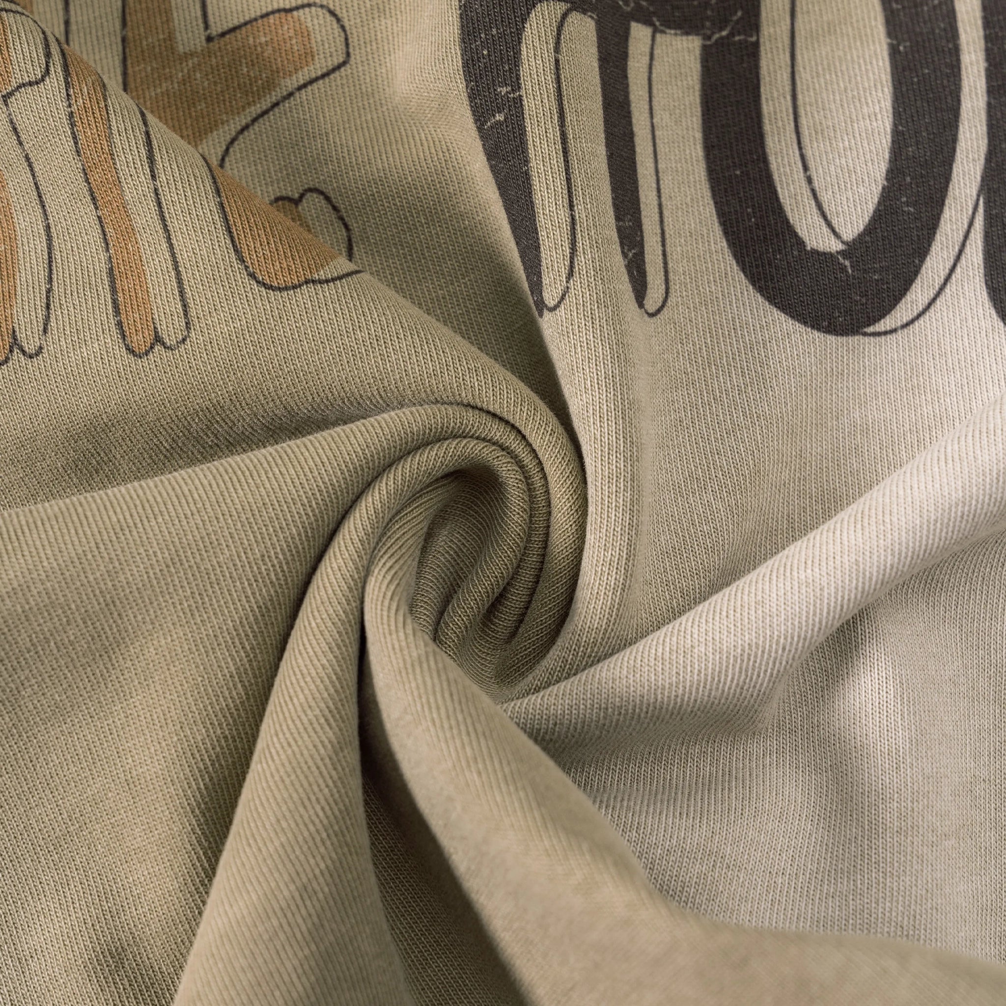 Close-up of beige fabric with printed text and shapes