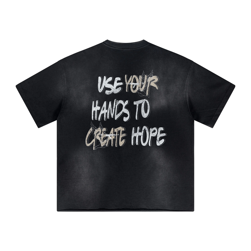 Black t-shirt with motivational text 'USE YOUR HANDS TO CREATE HOPE' on a white background