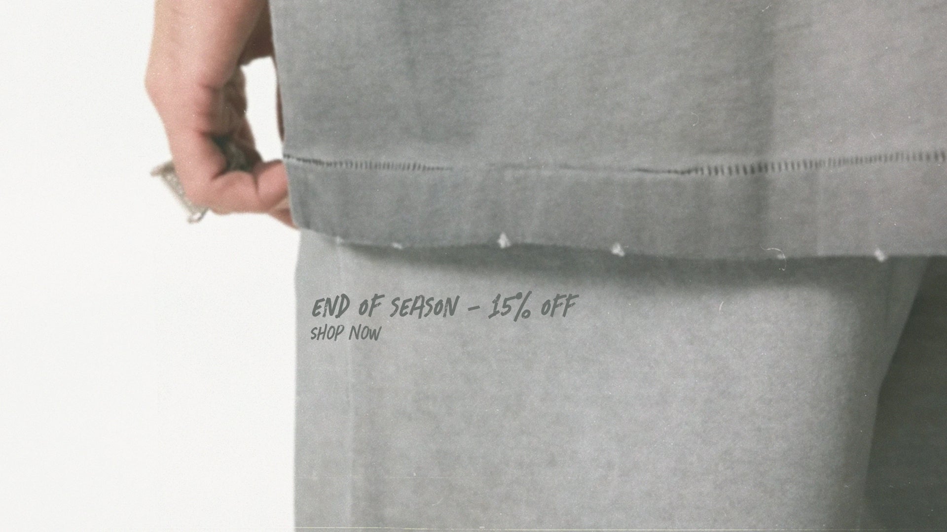 Gray sweatpants with text on the waistband against a light gray background
