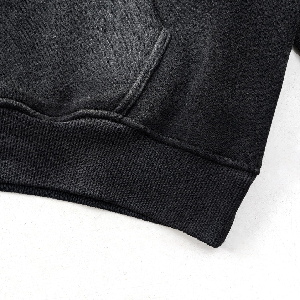 Close-up of a black hoodie on a white background
