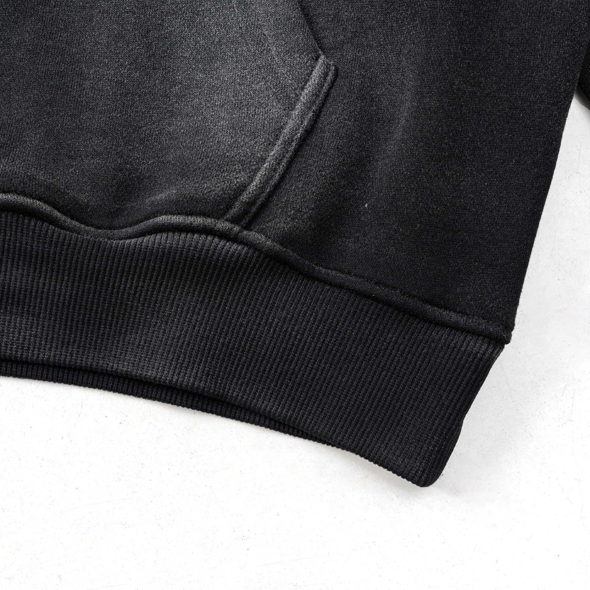 Close-up of a black hoodie on a white background