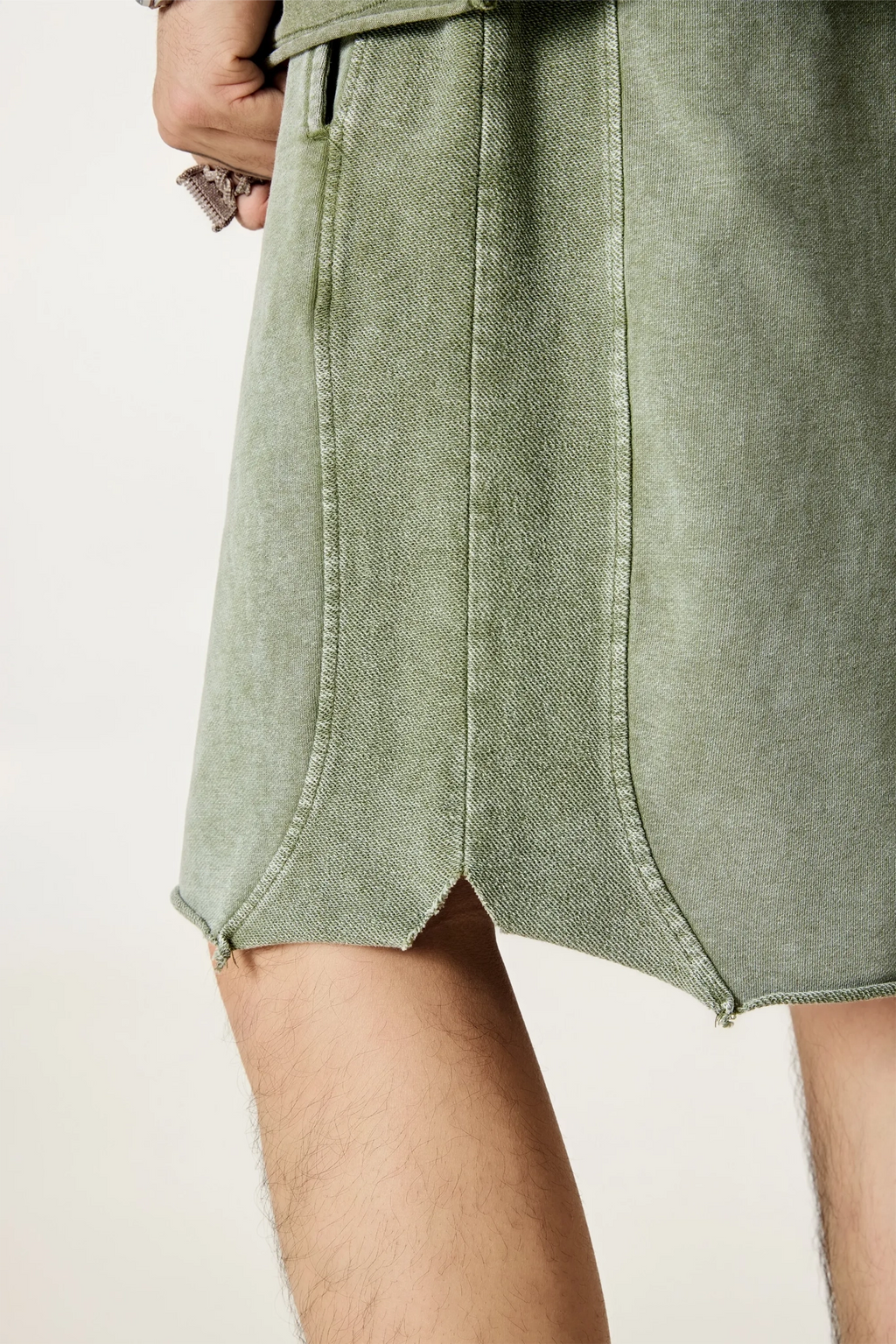Green denim skirt worn by a person on a plain background