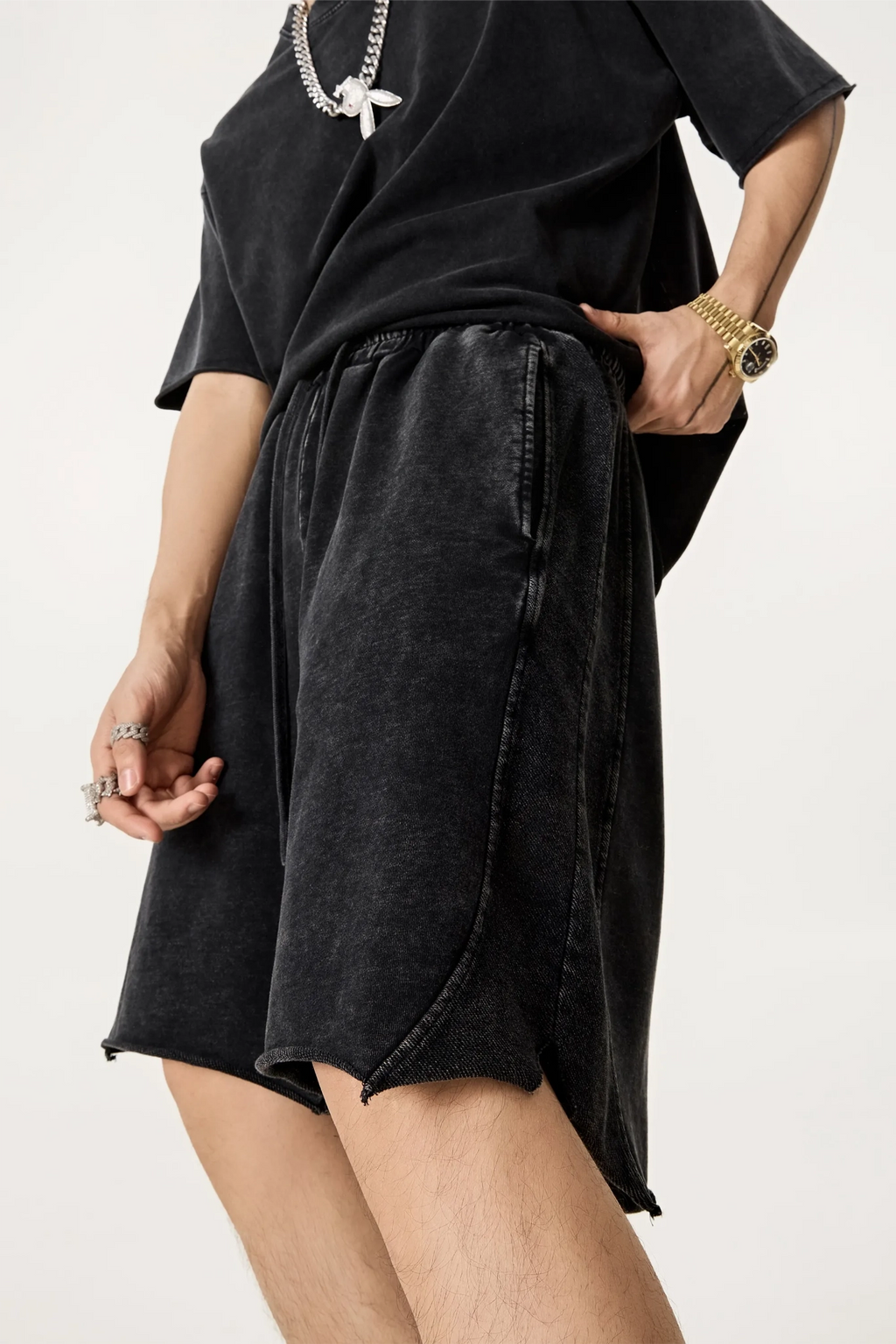 Person wearing a black outfit with a skirt and top on a white background