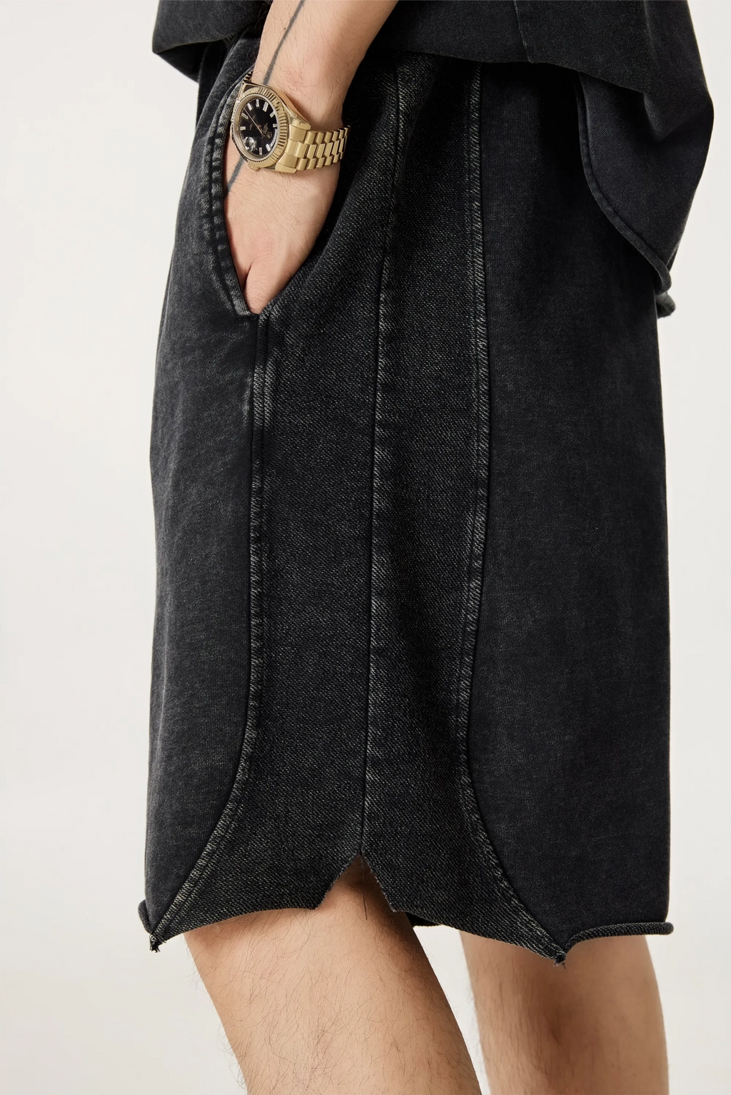 Black denim skirt worn by a person on a white background