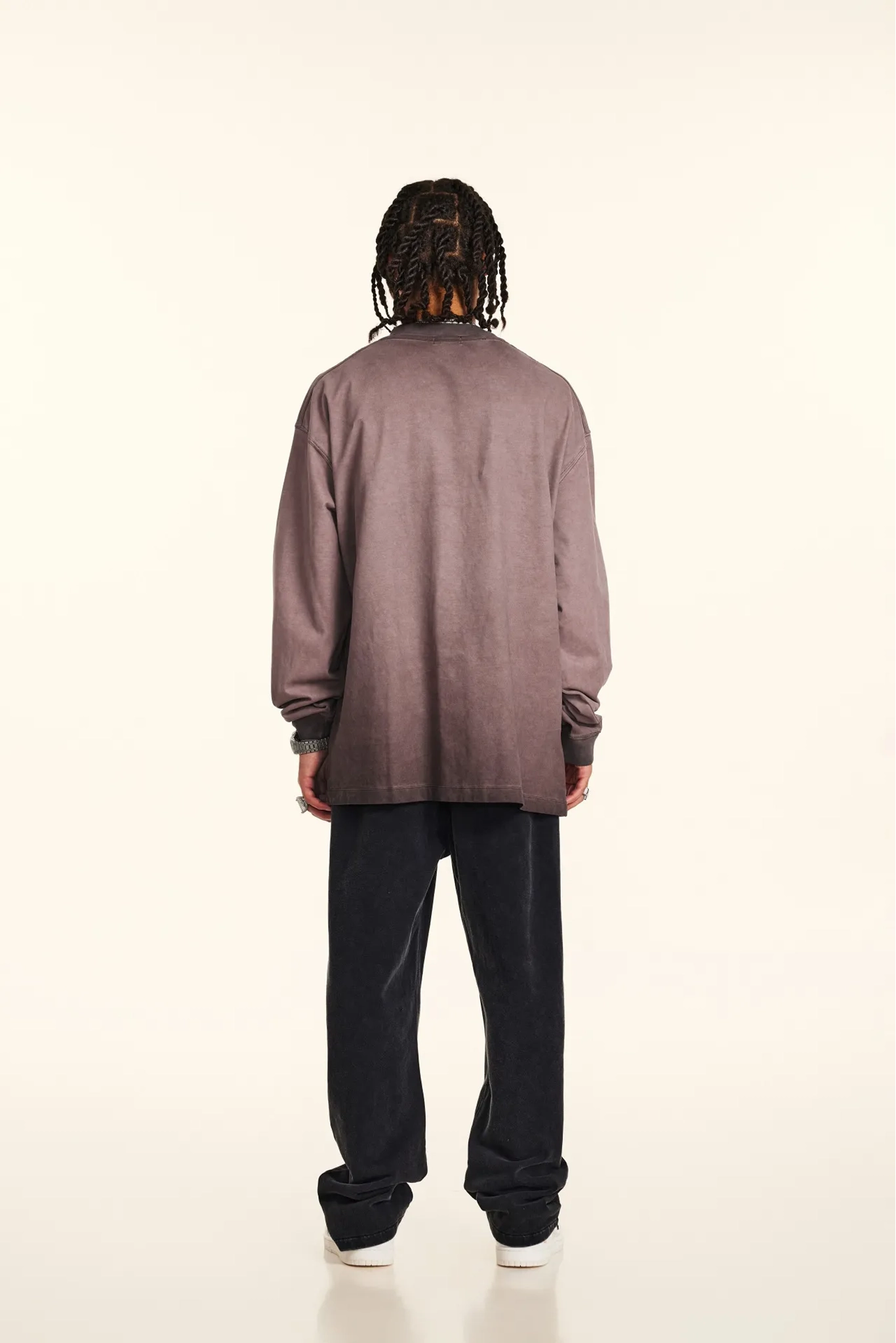 Person wearing a long-sleeve shirt and pants on a white background