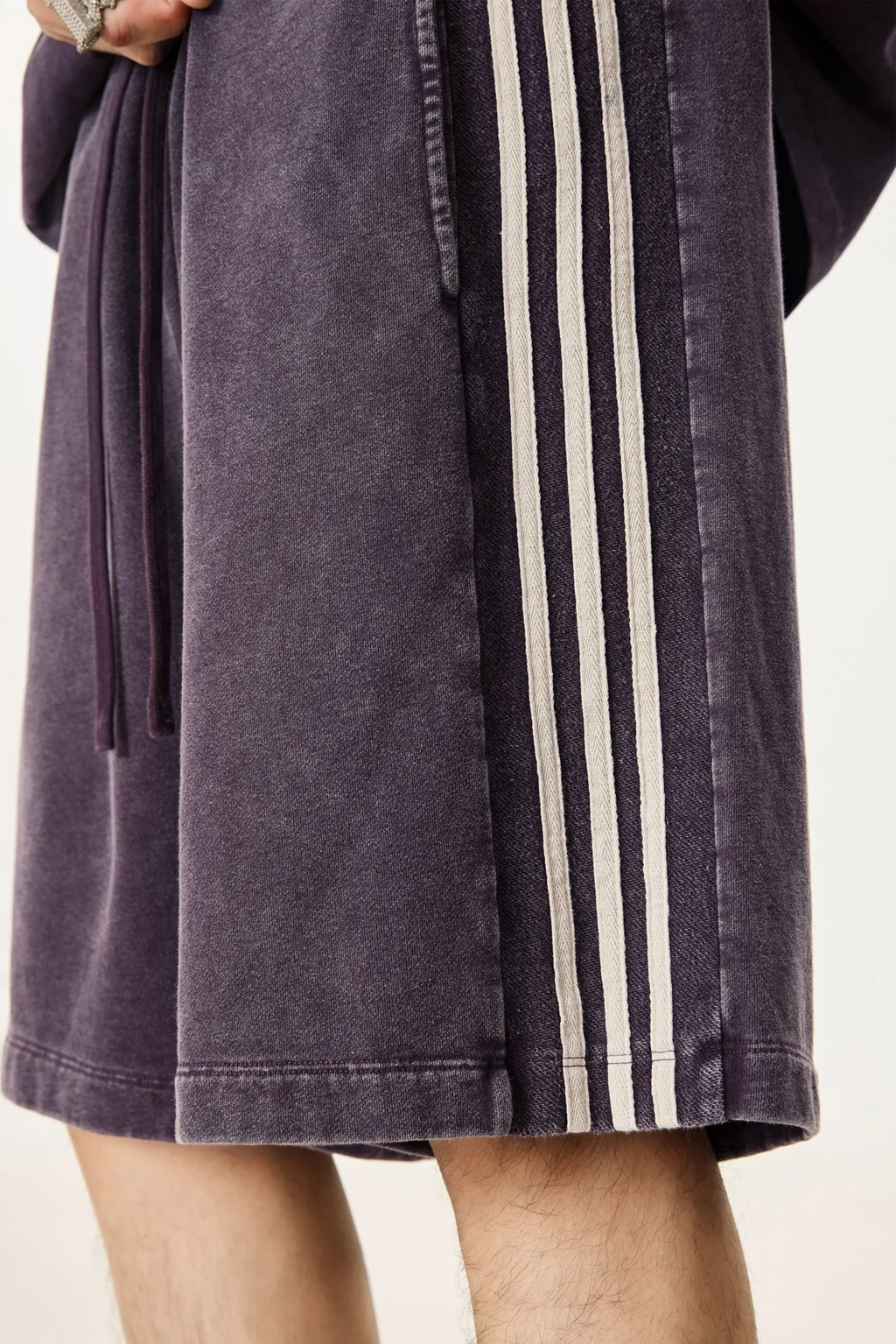 Purple robe with white stripes on a plain background