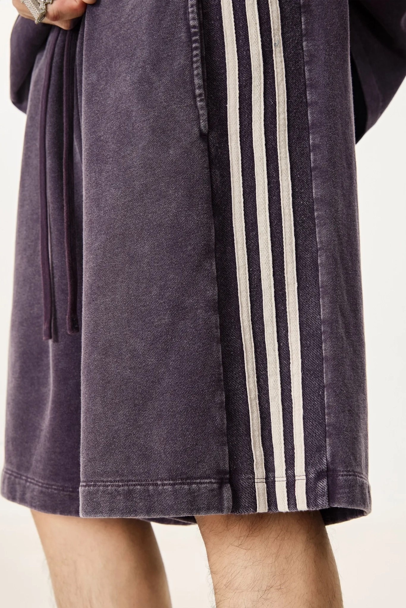 Purple robe with white stripes on a plain background