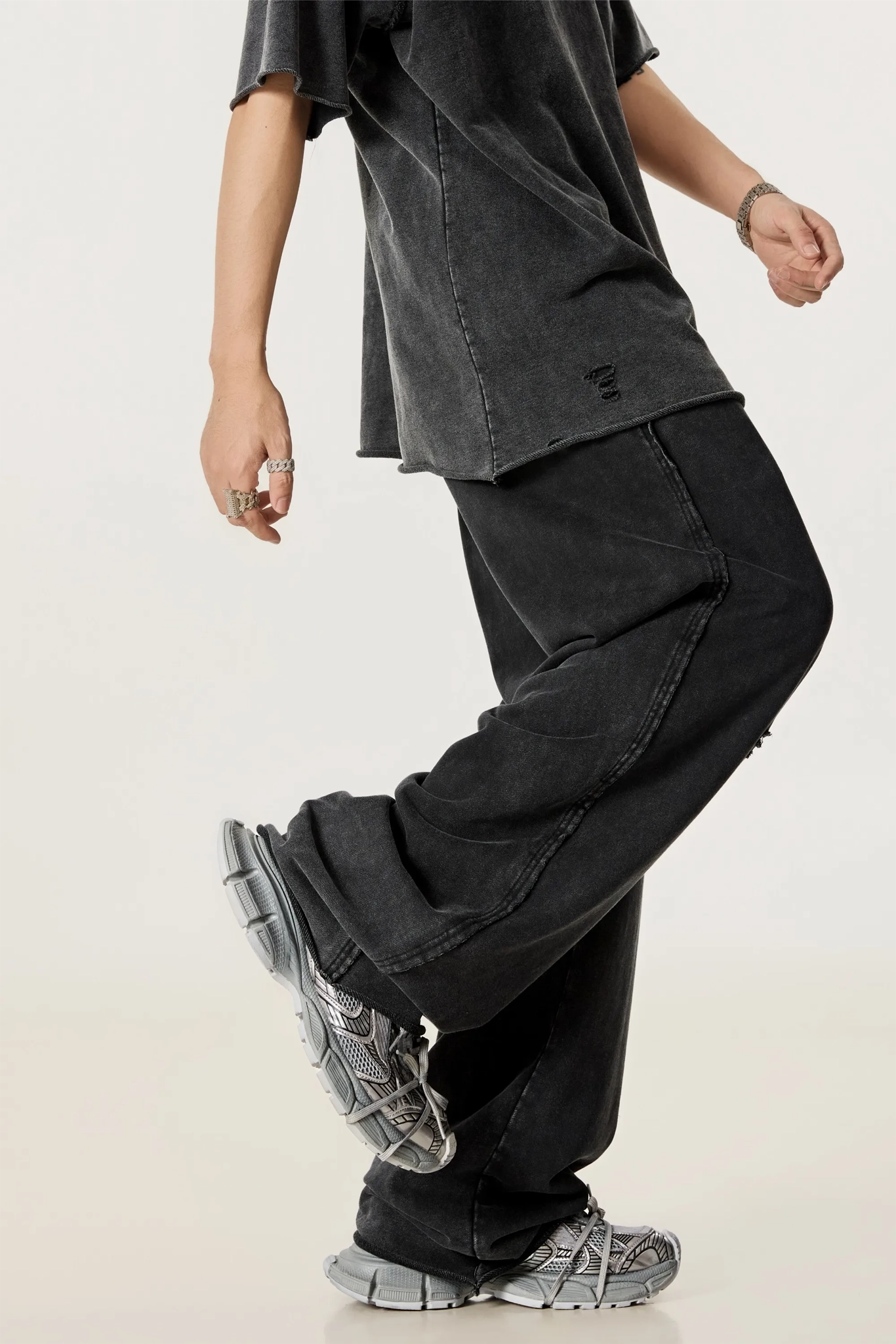 Person wearing black pants and shoes on a plain background