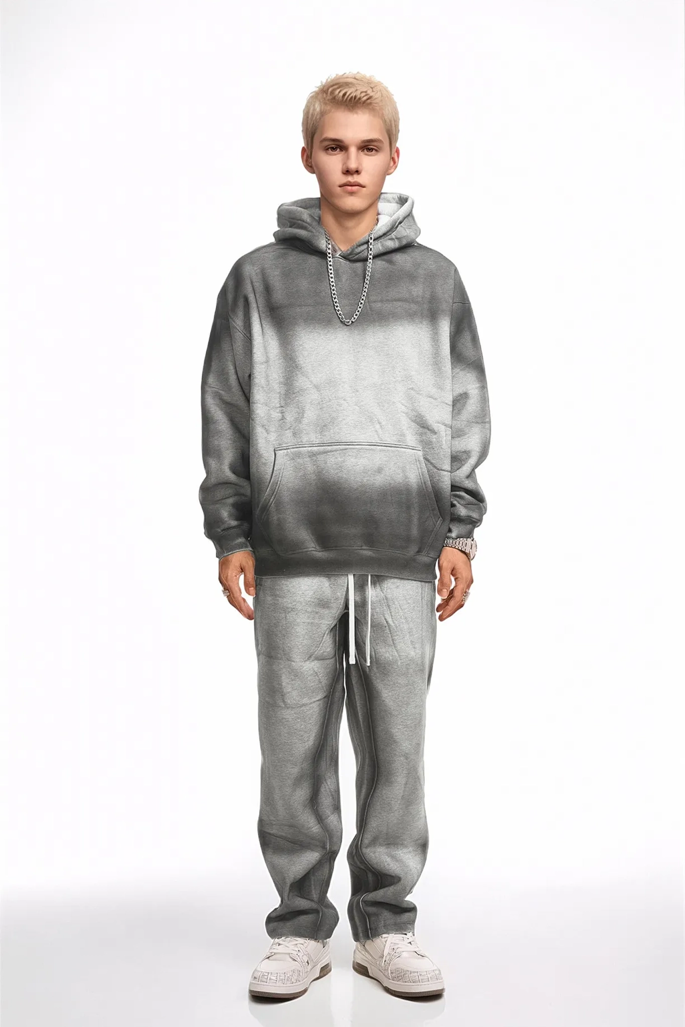 Person wearing a gray gradient hoodie and pants on a white background