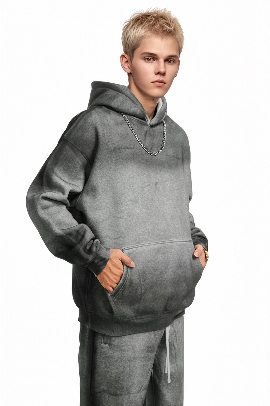 Person wearing a gray hoodie and pants on a white background