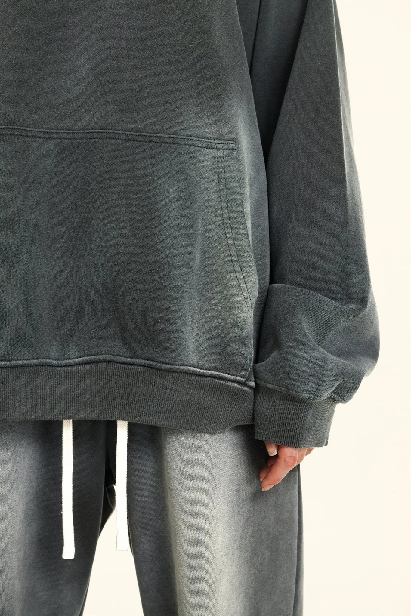 Gray oversized hoodie and pants on a neutral background