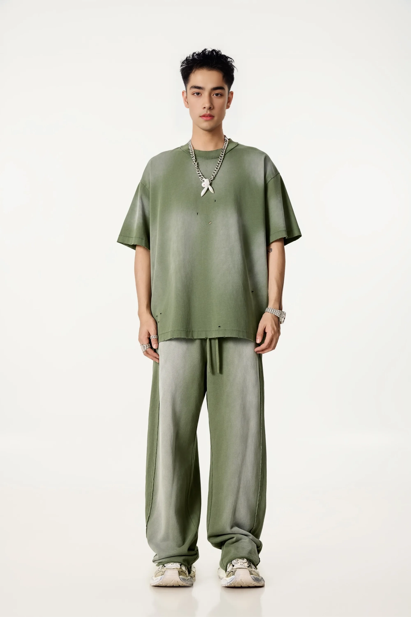 Person wearing a green outfit on a white background