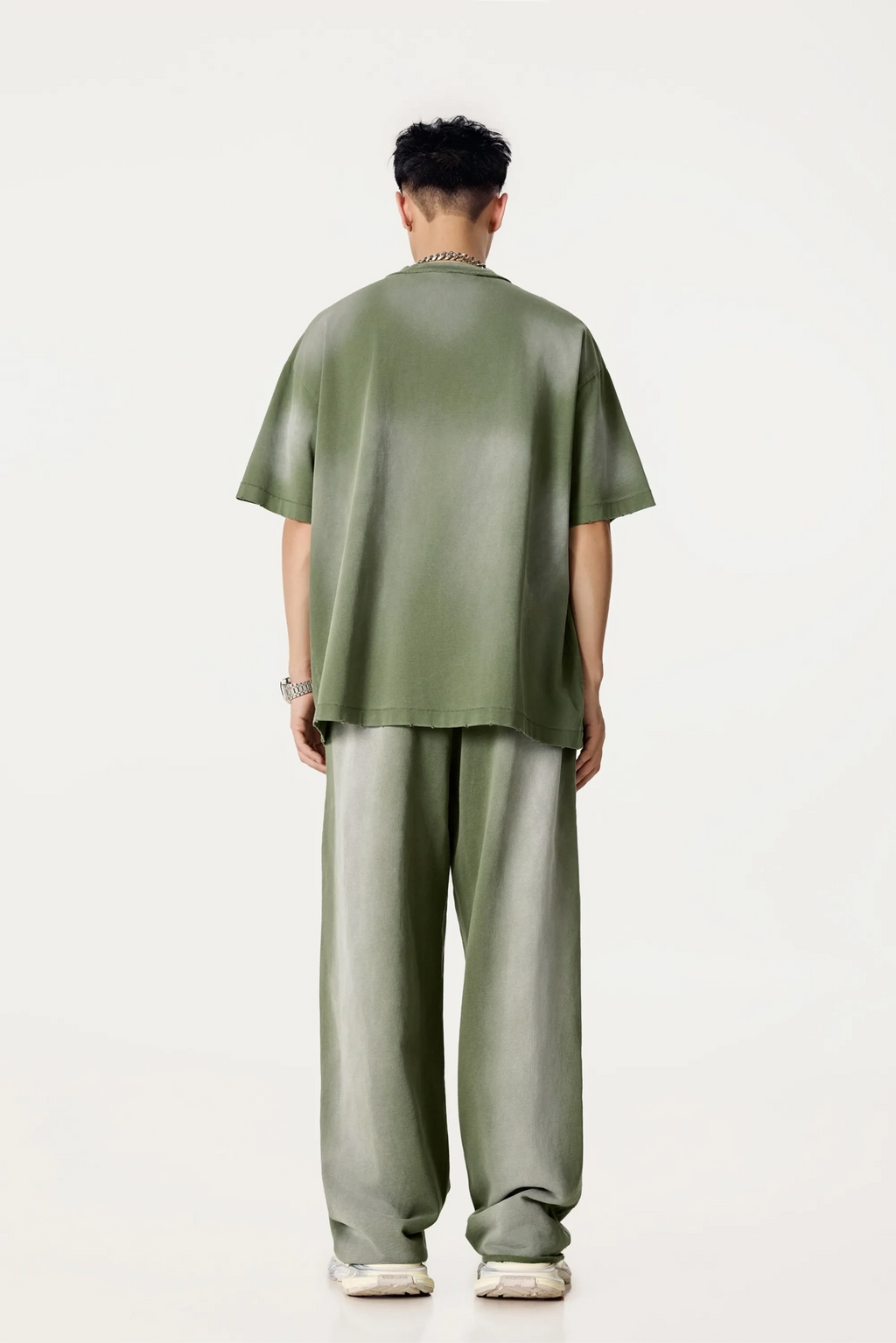 Person wearing a green outfit on a white background