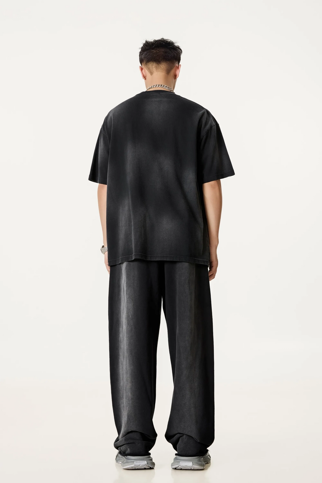 Person wearing a black outfit on a white background