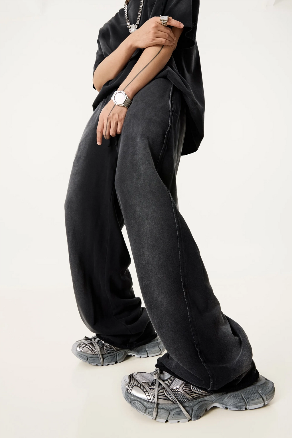 Person wearing black pants and shoes on a white background