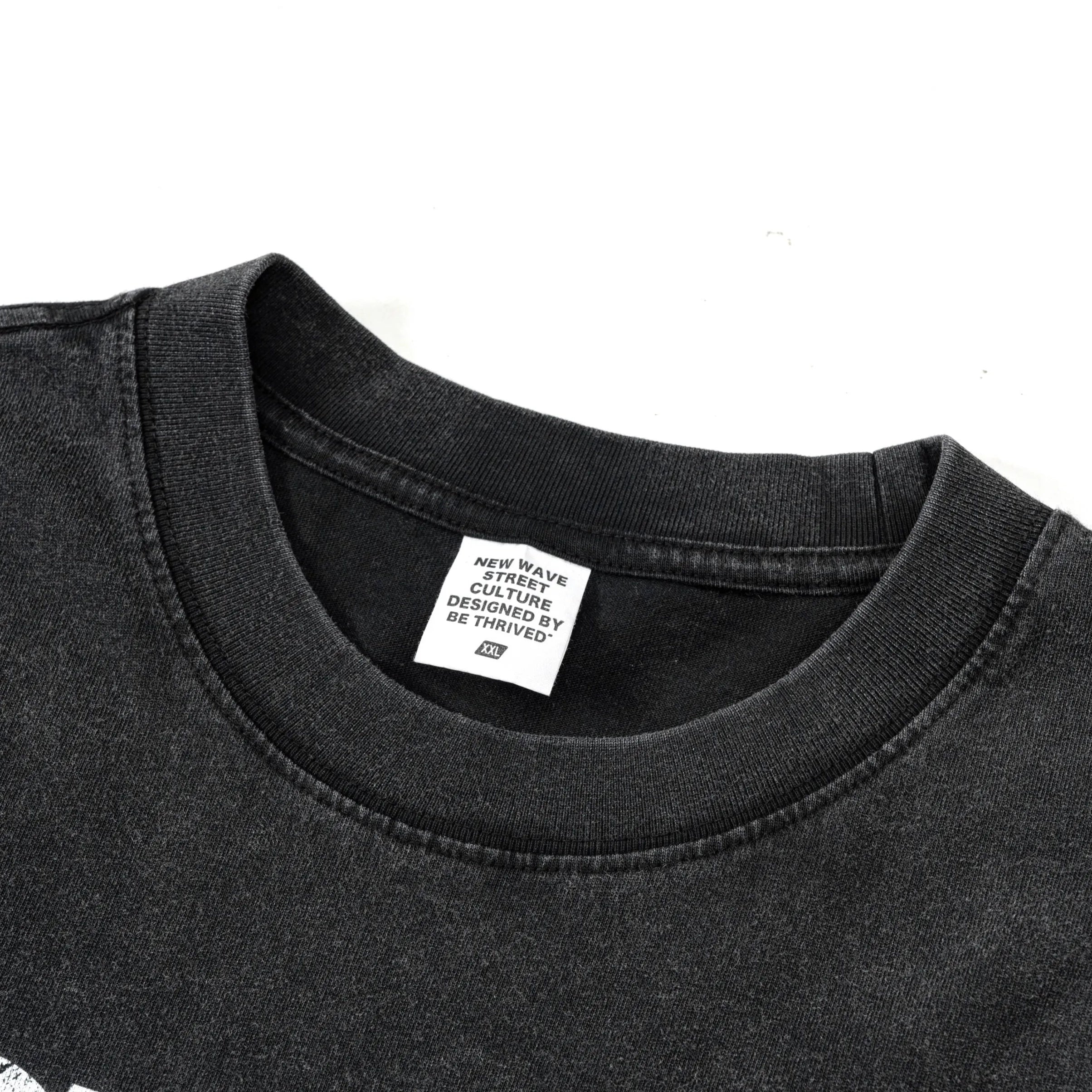 Black t-shirt with a brand label on a white background