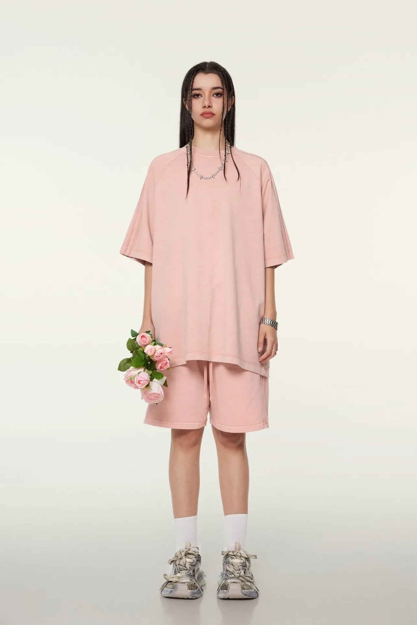 Person wearing a pink outfit with a white background