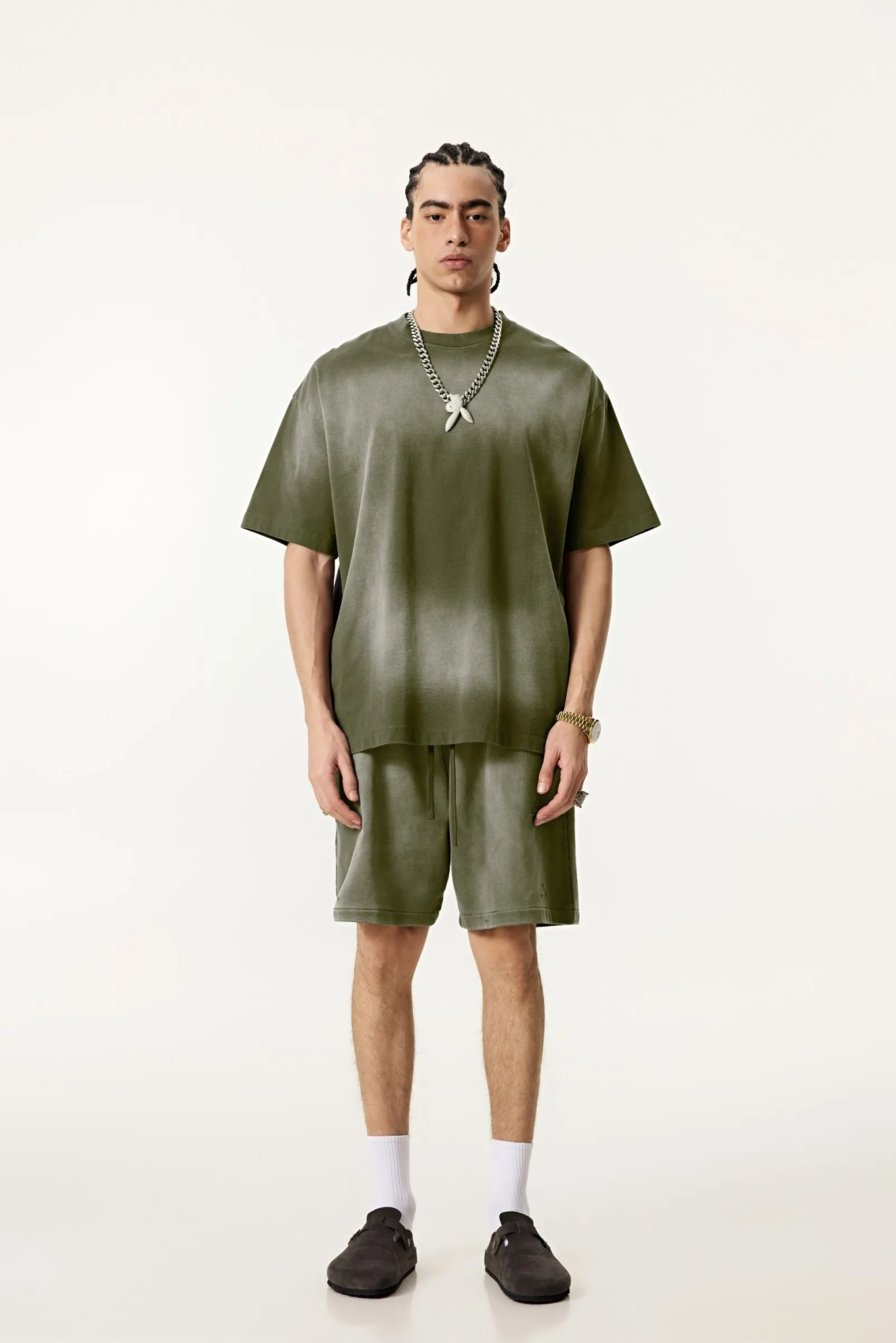 Person wearing a green outfit with a plain background