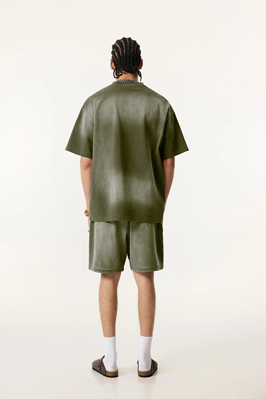 Person wearing a green outfit on a white background