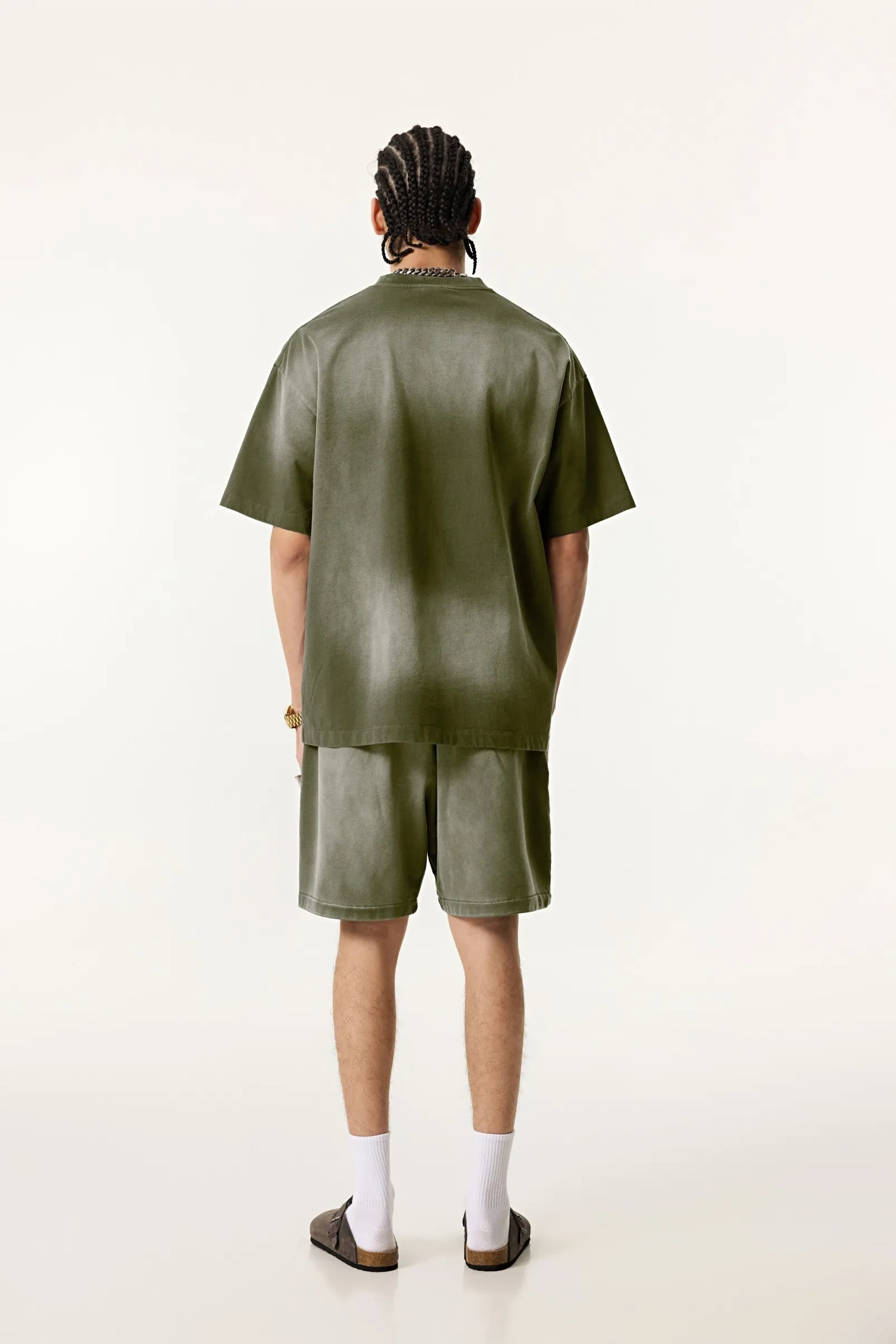 Person wearing a green outfit on a white background