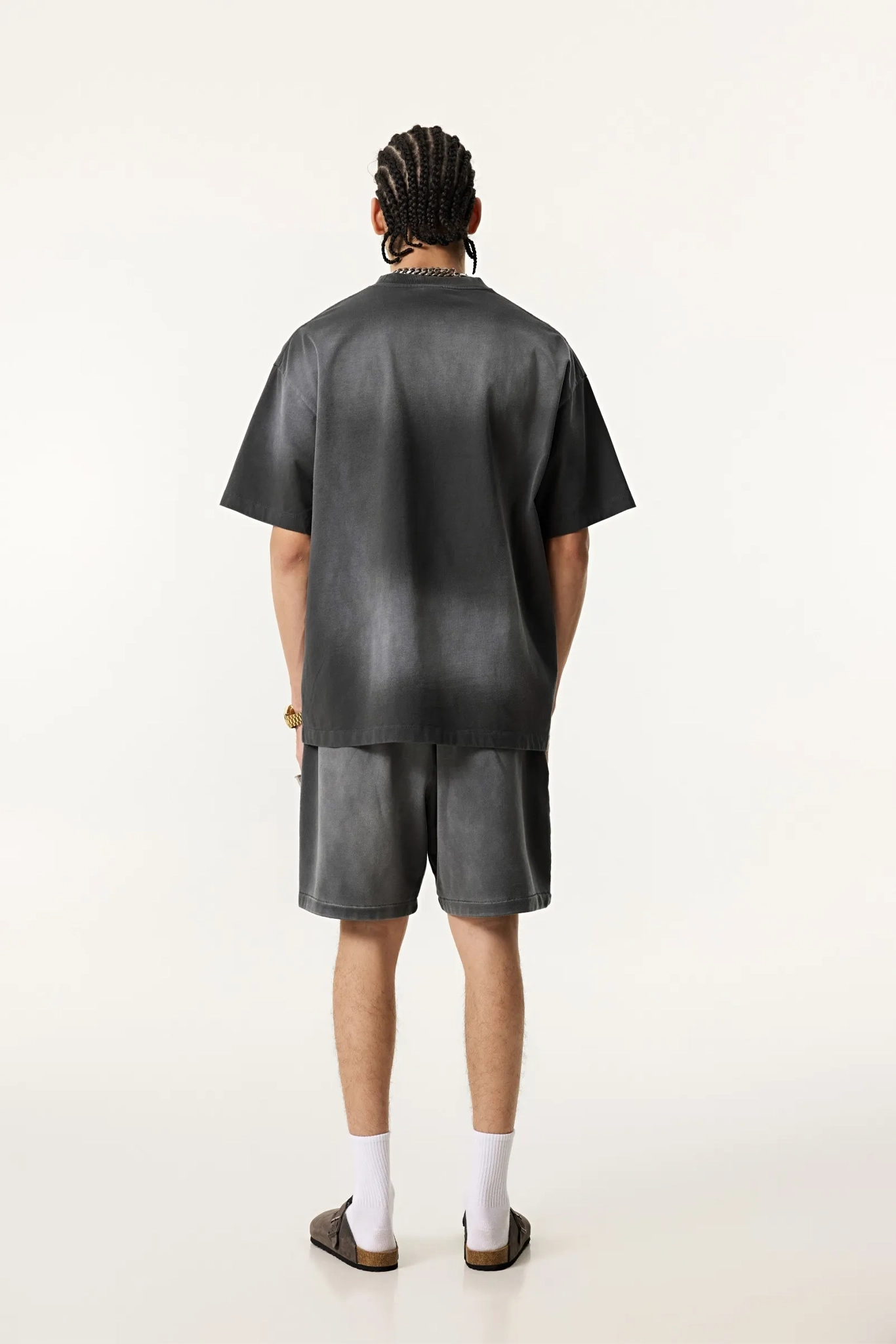 Person wearing a black leather outfit on a white background