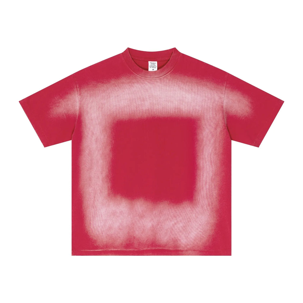 Red t-shirt with a spray paint design on a white background