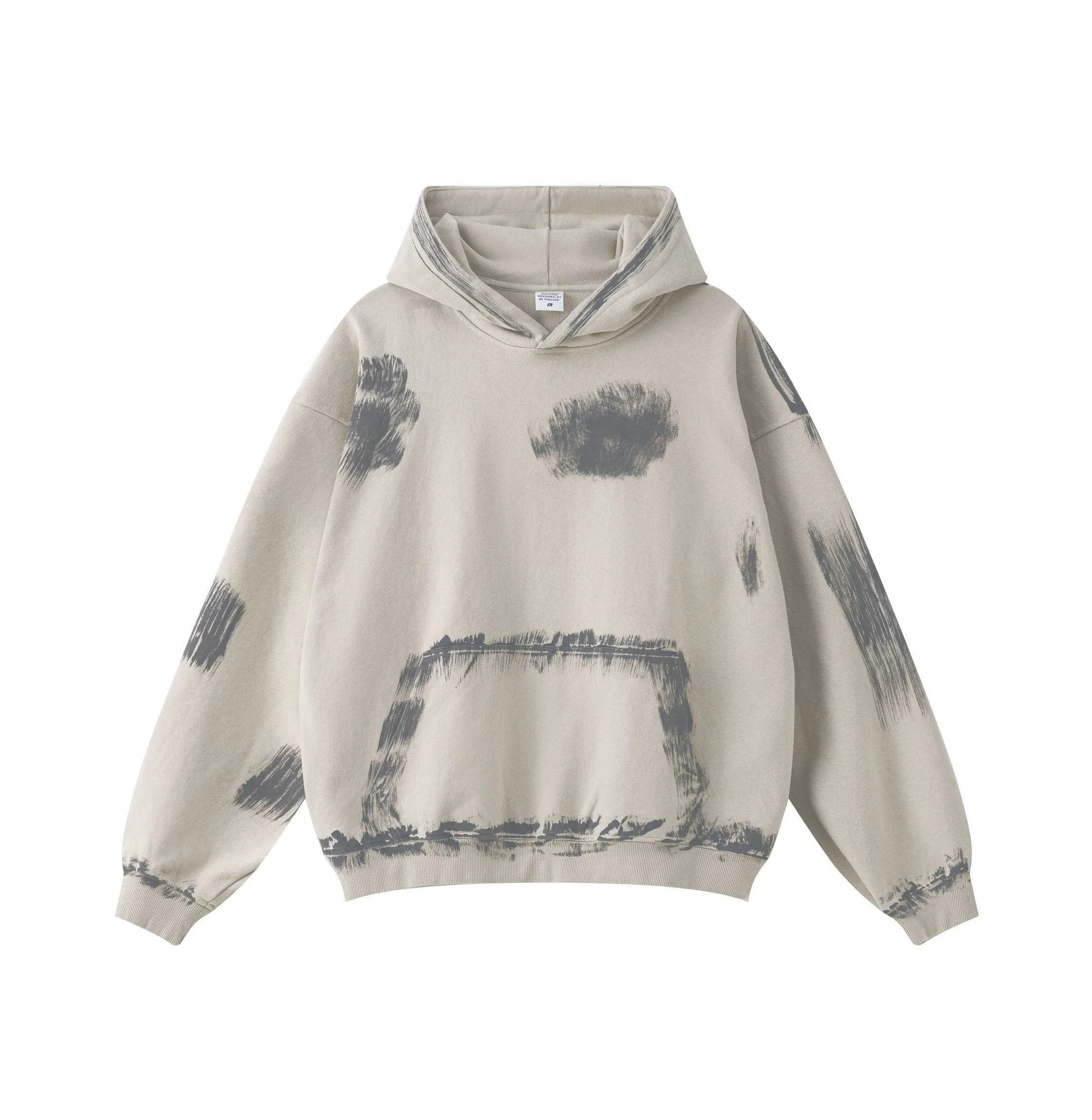 Beige hoodie with black abstract designs on a white background