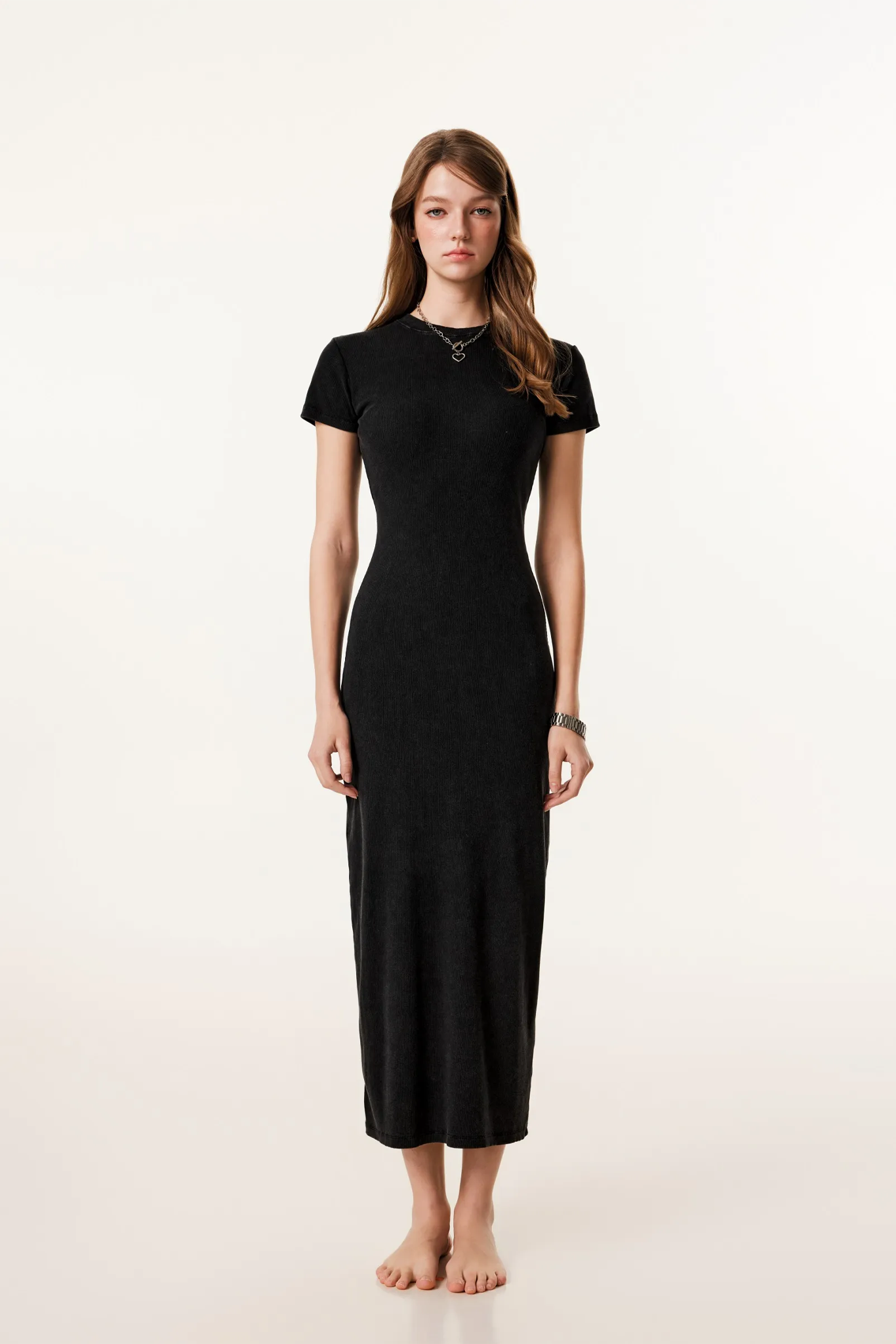 Woman wearing a black dress on a white background