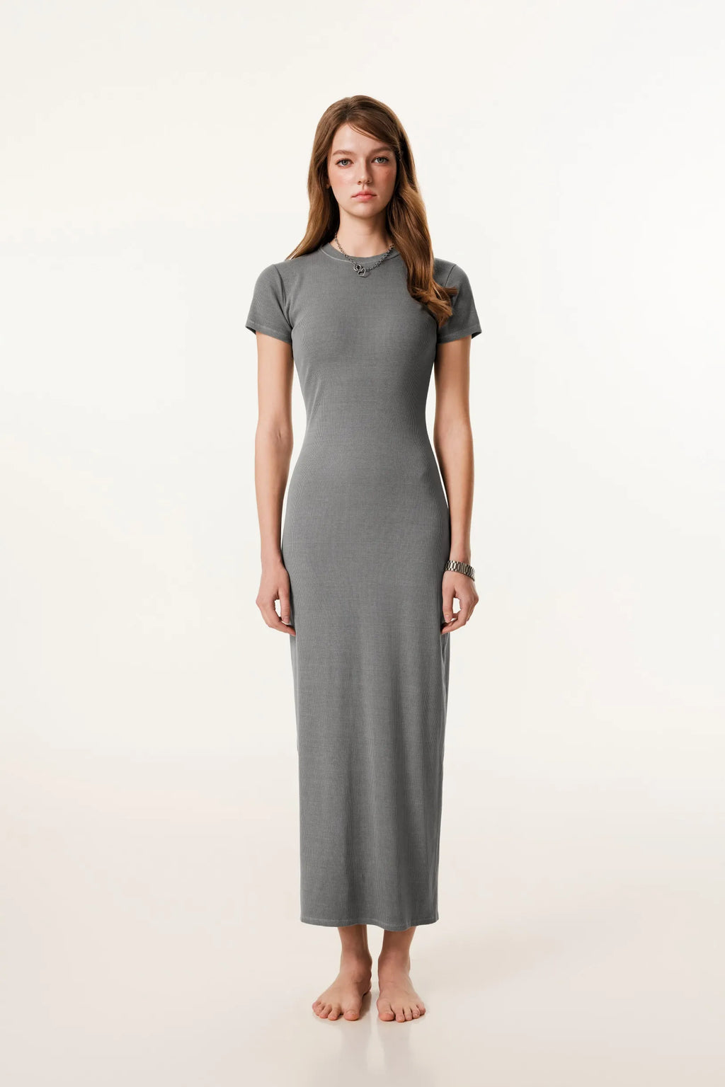 Woman wearing a gray dress on a white background